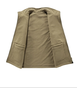 Detail of khaki fleece vest showing internal large pockets and durable zipper closure