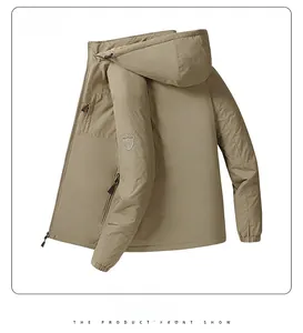 Detail view of khaki outdoor jacket featuring embroidered sleeve logo and ribbed cuff