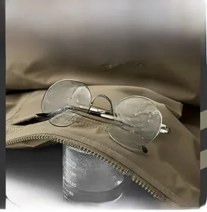 Close-up of khaki waterproof jacket fabric showing breathable moisture-wicking technology