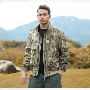 Detail of woodland camouflage tactical jacket with American flag patch on the sleeve