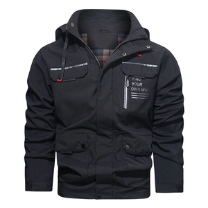 Detail of men's black hooded outdoor jacket with multiple pockets and classic plaid lining