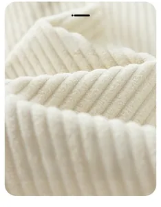 Macro view of windproof cream corduroy fabric with thick texture and ribbed detail