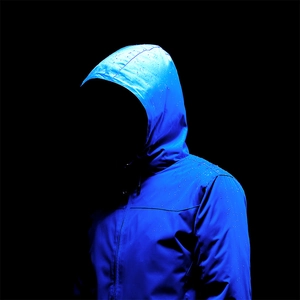 Close-up showing water droplets on blue waterproof hooded jacket surface