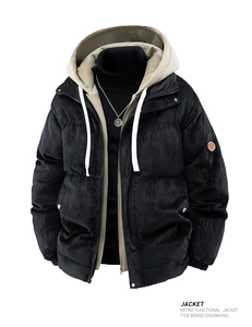 Detail of retro black corduroy jacket showing khaki hood lining and circular sleeve patch