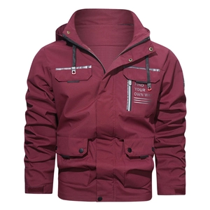 Detail of burgundy windproof jacket with hooded collar and cargo pockets for men