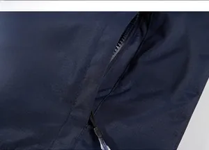 Detailed macro view of zipper pocket and fine stitching on navy outdoor jacket fabric