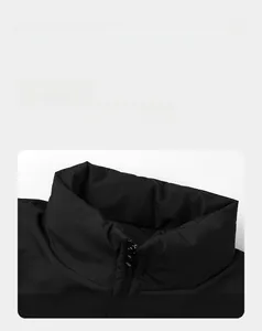 Detailed macro shot of the stand-up collar and smooth zipper on the black puffer jacket