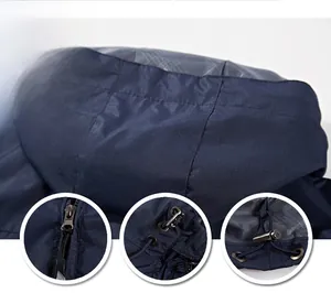 Detail view of navy blue outdoor jacket featuring adjustable drawstring hood and metal zippers