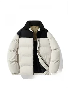 Detail of winter puffer jacket featuring a black stand collar and golden monogram lining