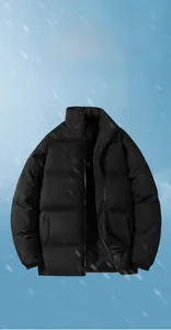 Detail of the stand collar and quilted texture on a thick black winter puffer jacket