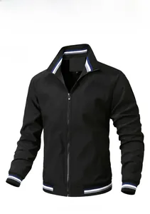 Detail of black stand collar jacket featuring blue and white striped ribbed cuffs and hem