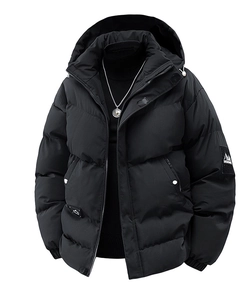 Detailed close-up of men's black winter coat featuring ribbed texture and designer arm patch