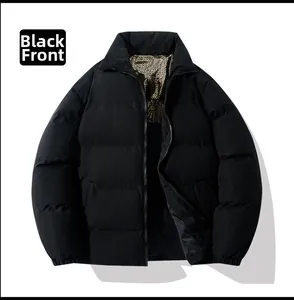 Detail of black puffer jacket showing zipper and golden monogram lining pattern