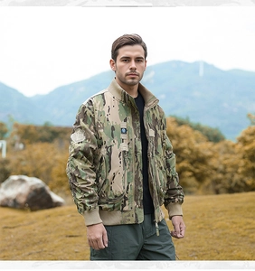 Detail of multicam tactical jacket featuring rib-knit collar and arm pocket on sleeve
