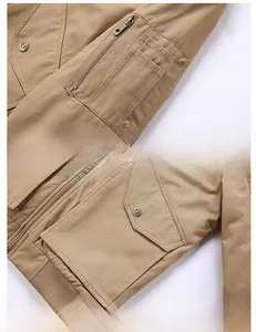 Detail of khaki cargo jacket featuring functional sleeve pocket and metal zipper closure