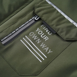 Detailed view of army green outdoor jacket with waterproof zipper and reflective pocket trim