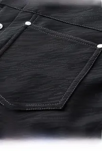 Macro detail of twill fabric texture and metal rivet reinforcement on chest pocket