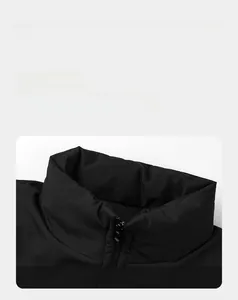 Close-up of the stand-up collar and smooth resin zipper on a black puffer jacket