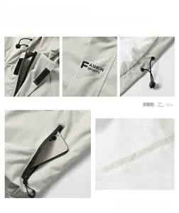 Detail view of adjustable hood drawstrings and Velcro windproof placket on light gray jacket