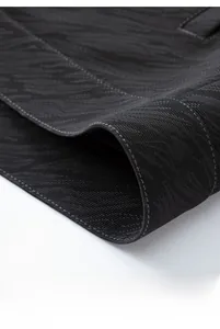 Macro detail of the dark gray jacket hem featuring precise stitching and textured fabric