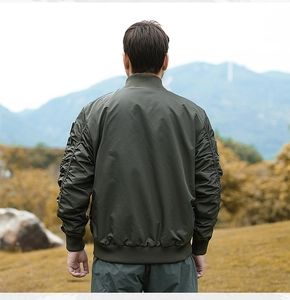 Close-up of olive green bomber jacket featuring ruched sleeves and ribbed cuffs details