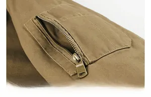 Detail of cargo jacket sleeve featuring a bronze metal zipper pocket and twill cotton texture