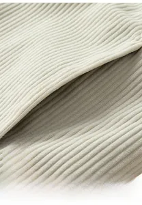 Detail view of corduroy texture and pocket stitching on beige winter jacket