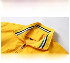 Detail view of the yellow stand collar jacket with tricolor striped ribbing and front zipper