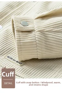 Detail view of corduroy jacket cuff with matte metal button and branded woven label
