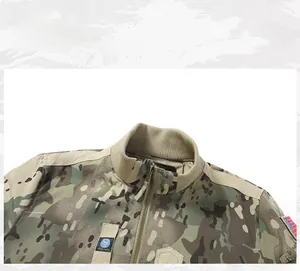 Detail of MA1 flight jacket featuring tactical camouflage pattern and embroidered chest badges