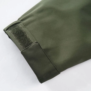Close-up of army green jacket cuff with adjustable velcro strap and durable stitching