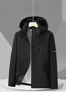 Detail of black waterproof outdoor jacket showing windproof hood and zippered chest pocket