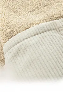 Detail view of the inner corduroy pocket and soft lamb fleece lining of the warm jacket