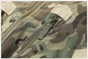Detailed macro view of heavy-duty metal zipper and camo fabric stitching on pilot jacket