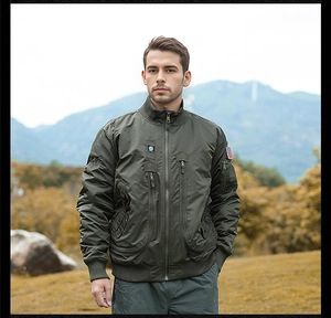 Detail of olive green tactical flight jacket with zip pockets and flag patch