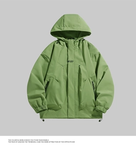 Detail view of grass green windbreaker with hood, zip pockets and adjustable drawstring