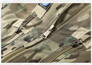 Detail of army jacket featuring camouflage pattern with multiple metal zippers and embroidery
