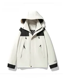 Close-up of ivory and black outdoor windbreaker with adjustable hood and cuffs
