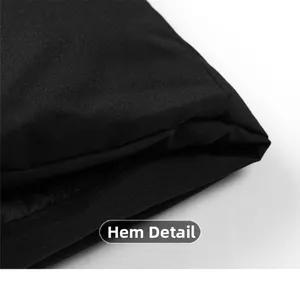 Close-up macro view of the hem details and stitching on a black padded winter jacket