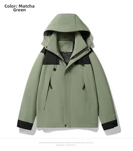 Detail view of matcha green outdoor windbreaker with black shoulder panels and hood