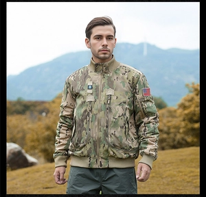 Close-up of tactical camo bomber jacket with US flag patch and functional zipper pockets