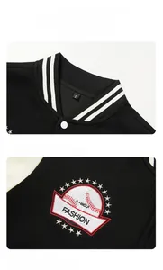 Detail of embroidered fashion text and star logo on a black baseball varsity jacket