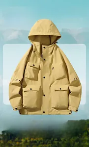 Detail of yellow hooded windbreaker with four large flap pockets and mountain background