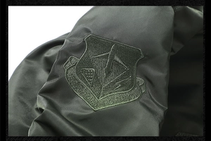 Detail of embroidered shield badge with aircraft icon and Fighting text on bomber jacket