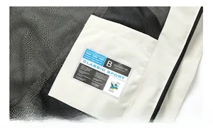 Detail of breathable black mesh lining and functional inner pocket on white outdoor jacket