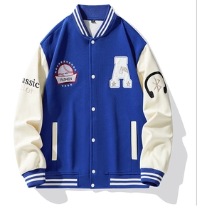 Detail of blue varsity jacket with embroidered A letter patch and striped ribbed collar