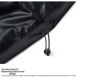 Detail of adjustable elastic drawstring hem with metal eyelet on black outdoor jacket