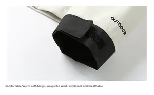Detail of adjustable velcro cuffs on outdoor windbreaker with off-white and black fabric