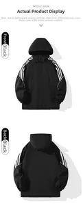 Detail view of the black waterproof jacket with white stripes on sleeves and hidden pockets
