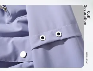 Detail view of light purple jacket sleeve with metal eyelet decoration and precise stitching